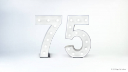 Illuminated marquee-style numbers "75" against a simple white background.